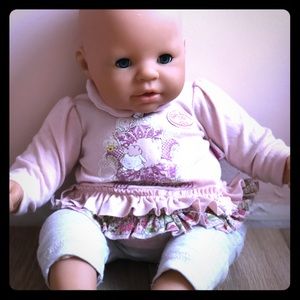 A set of twin baby dolls and a kitchen table set